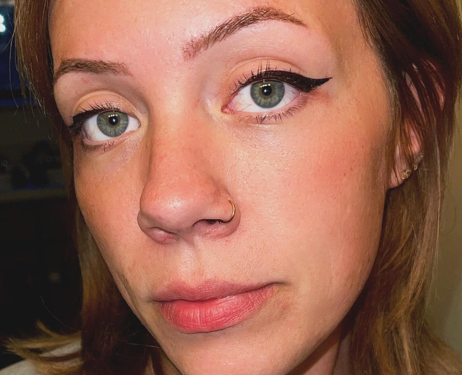 Customer wearing eyeliner at an outdoor event